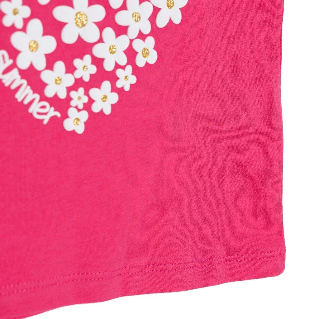 Pink baby T-shirt hem and side seam, with floral heart graphic partly visible