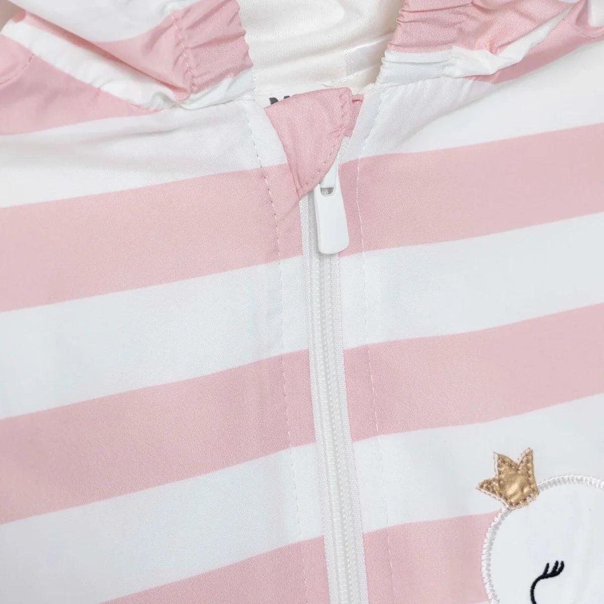 Close-up of pink-and-white striped raincoat with zipper pull and stitched hood seam.