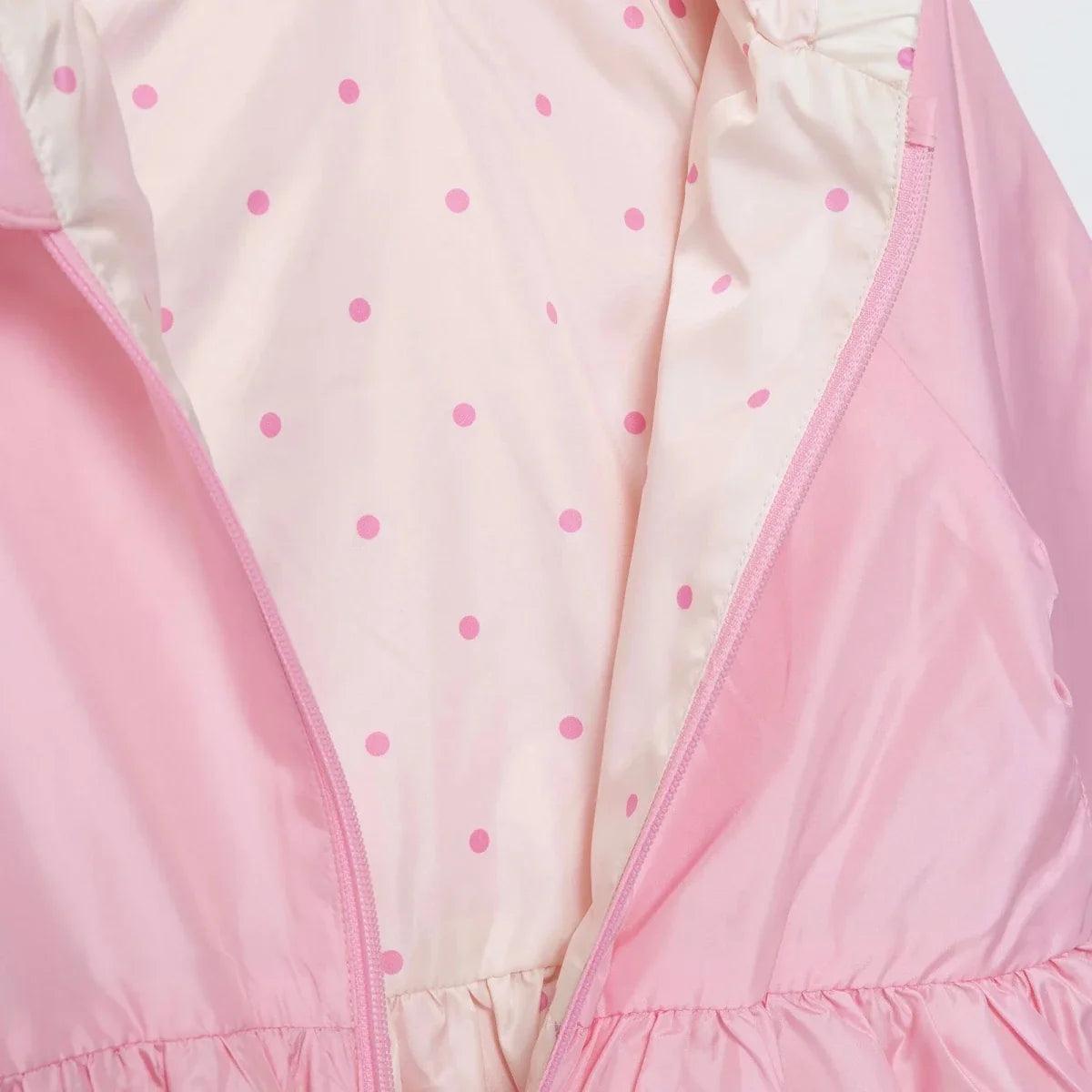 Pink-lined hooded baby raincoat interior with small dot print