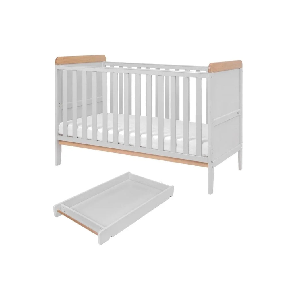 Dove grey cot bed with light wood rails and the pull-out mattress base