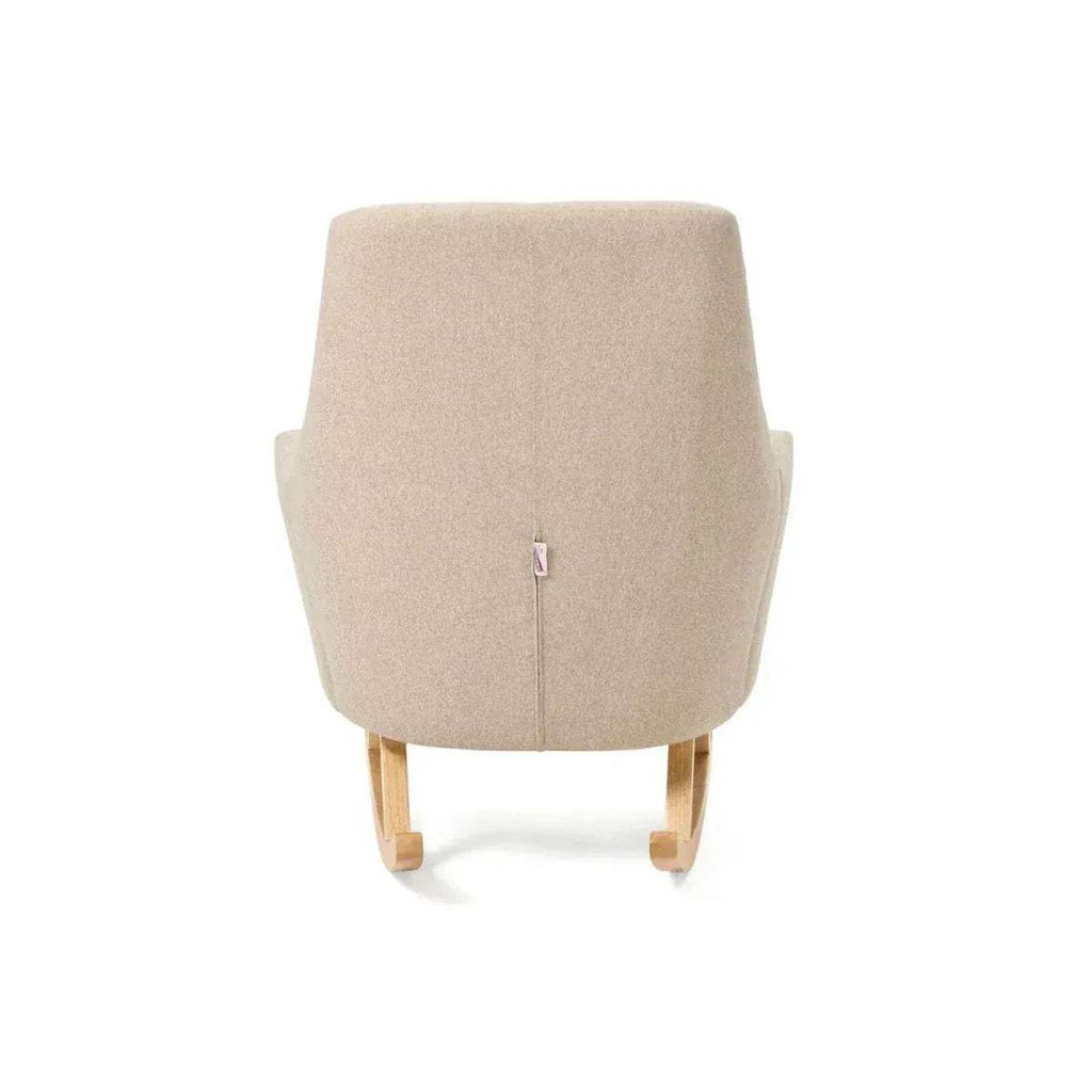 Stone upholstered rocking chair front view with vertical tuft seam and wood runners.