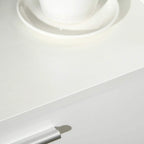 White drawer pull on the lower drawer front of a kitchen cupboard