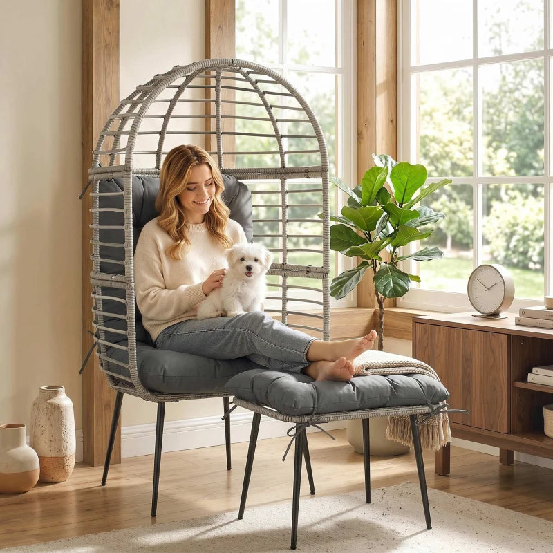 Rattan egg lounge chair with thick light grey seat cushion and matching ottoman