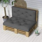 Dark grey padded pallet cushion set with button-tufted backrest and seat on wooden slats