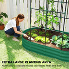 Green raised garden bed with arched trellis, gardener planting vegetables in soil