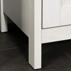 Antique white freestanding cabinet with slim legs and open clearance at the base
