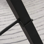 Black steel support bar on gravity inversion table frame, close-up