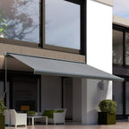 Grey cassette retractable awning mounted above a building window and door