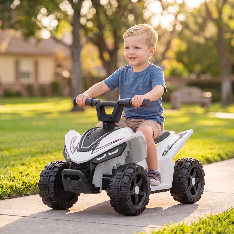 White kids quad bike with black handlebar, child riding on concrete patio