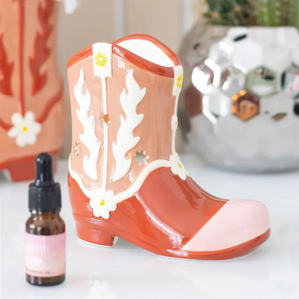 Orange cowboy boot oil warmer with white flame motifs and included oil bottle