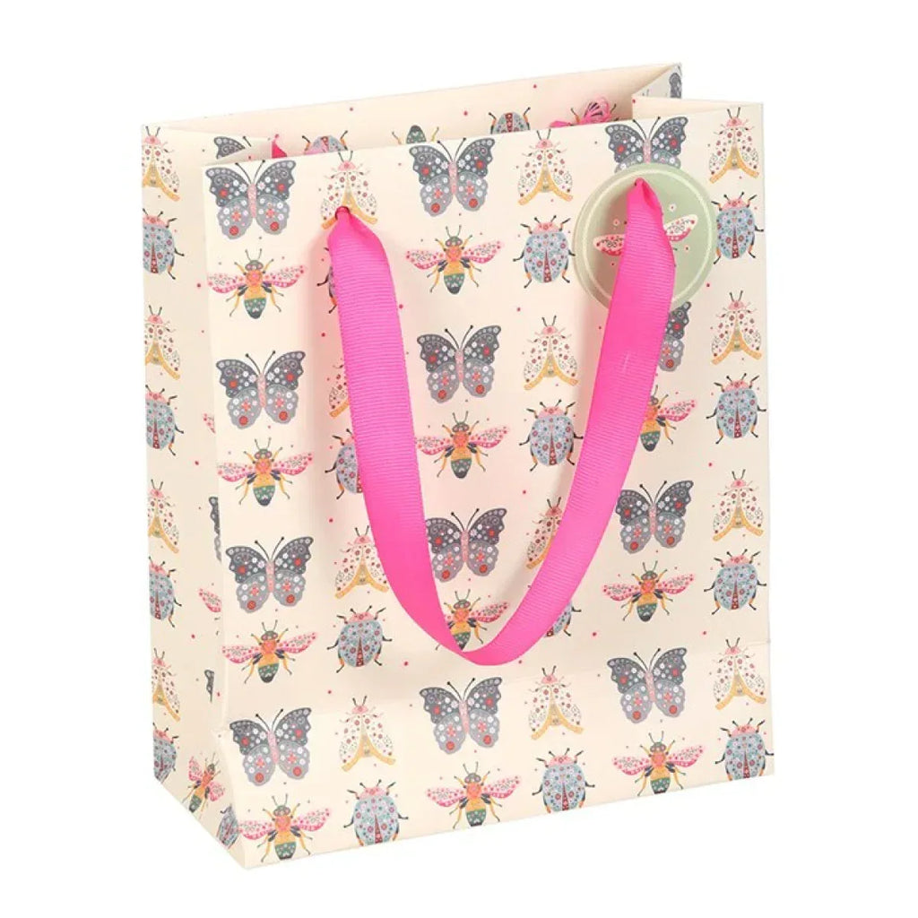 Medium gift bag front with pink rope handles and repeating floral bug print