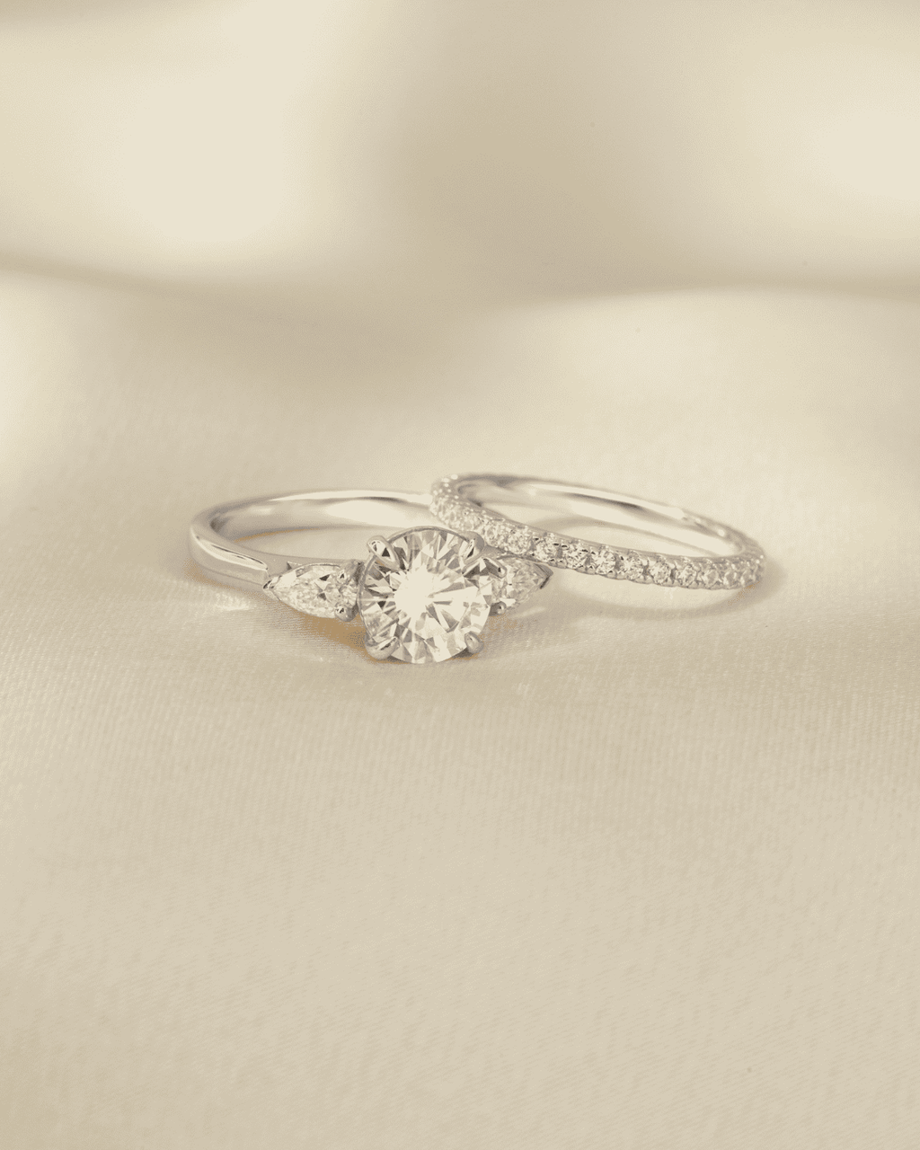 Sterling silver three-stone moissanite ring with round center stone, side view