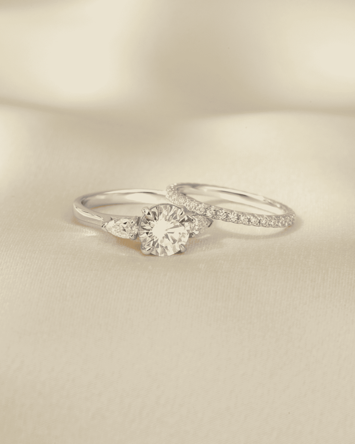 Sterling silver three-stone moissanite ring with round center stone, side view