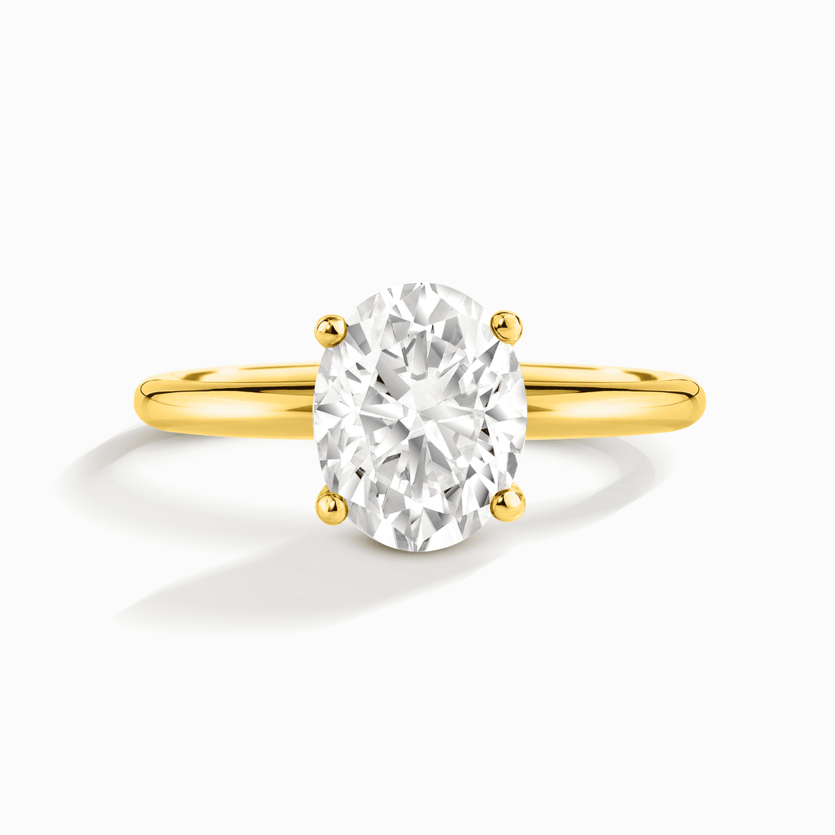 Oval solitaire moissanite ring with gold-tone band and four-prong setting
