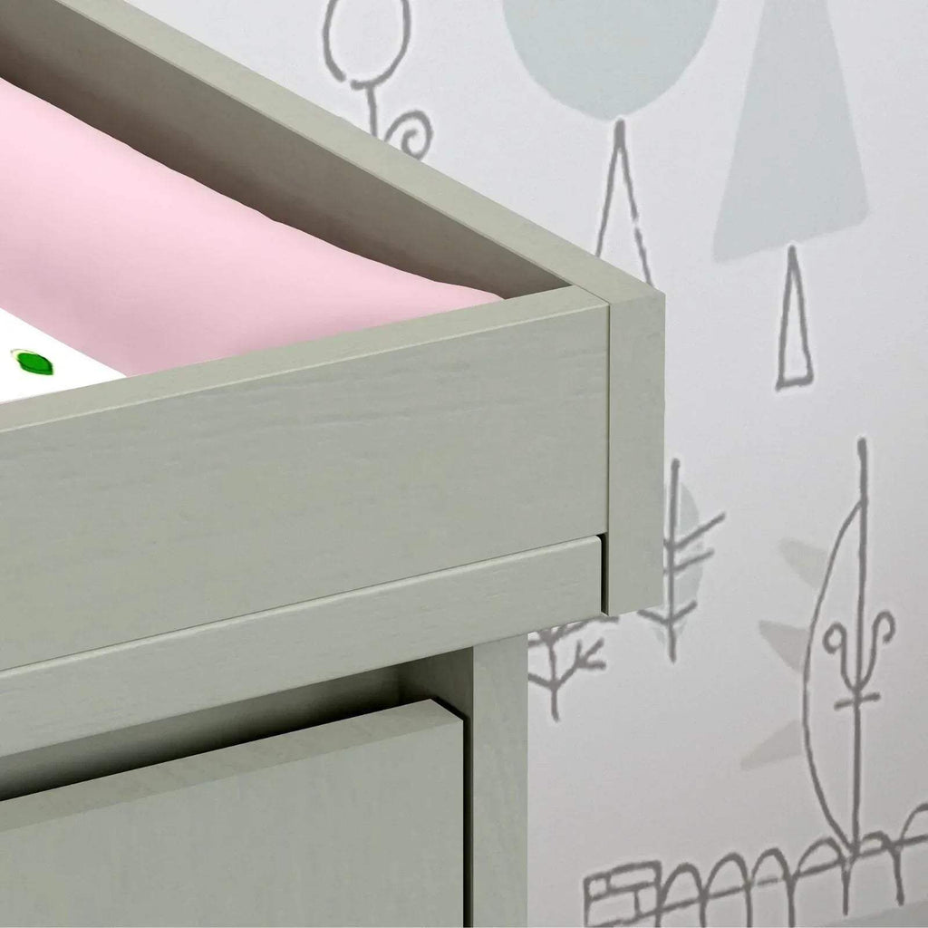 Close-up of grey changing unit rail and drawer opening edge