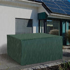 Green patio furniture cover over rectangular set outdoors, with elastic hem and securing points.