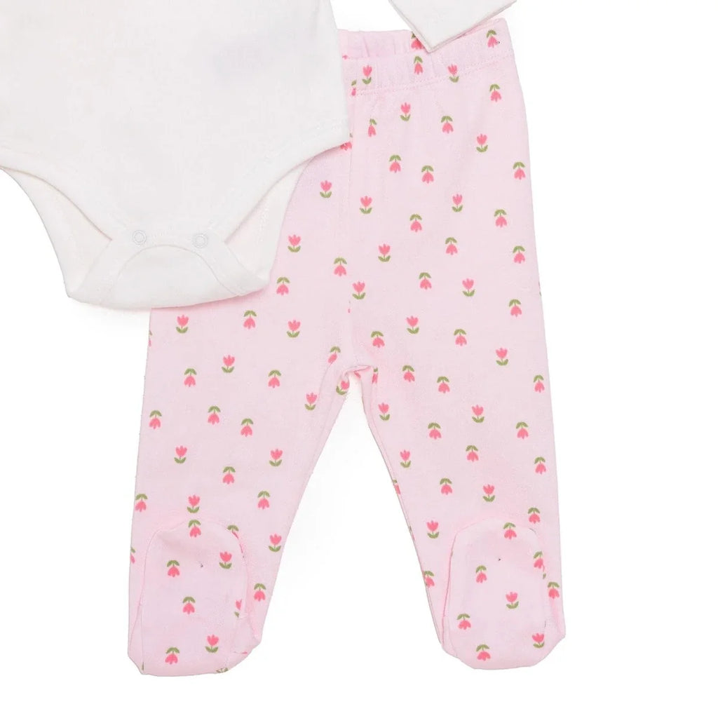 Pink tulip-pattern footed pants with white bodysuit front, shown cropped