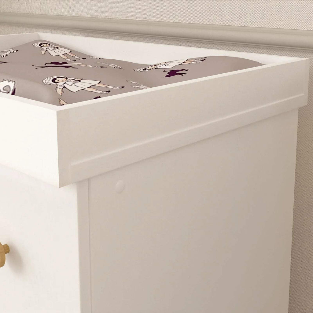 White changing dresser with raised rail and printed changing pad