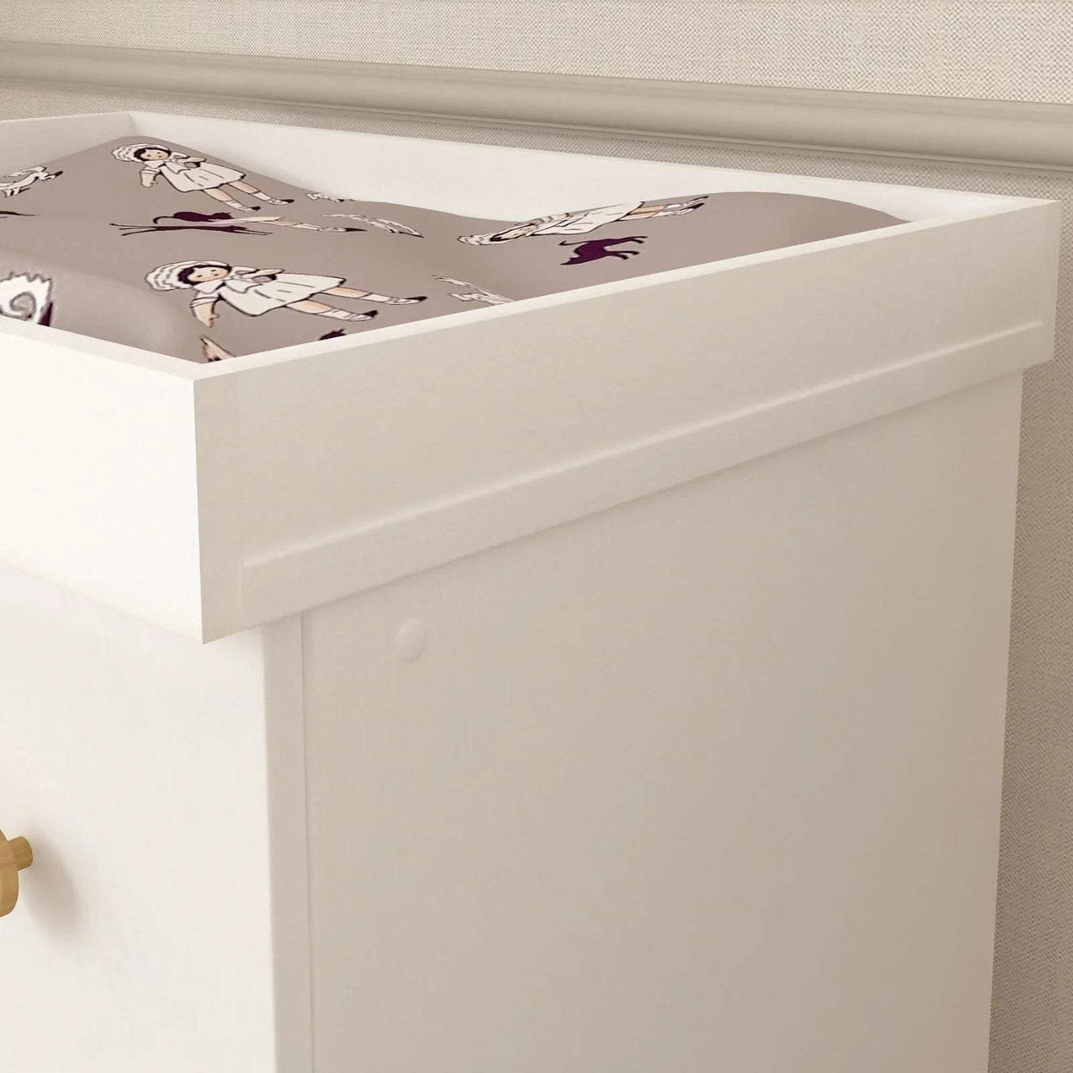 White changing dresser with raised rail and printed changing pad