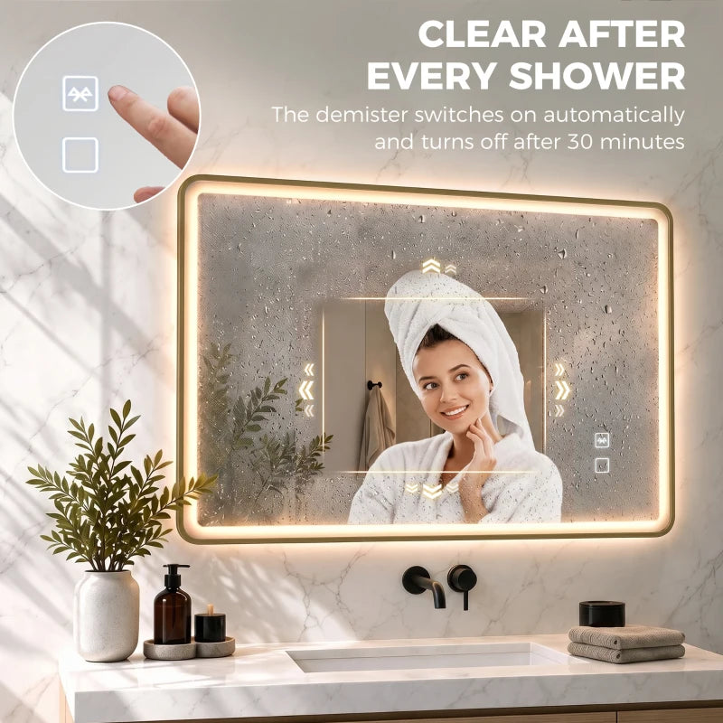 Gold-tone rectangle LED bathroom mirror with anti-fog window and steam-clearing indicator.