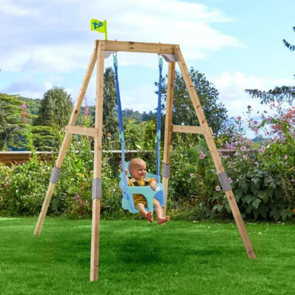 Wooden swing set with two blue hanging swings; child seated on one swing.
