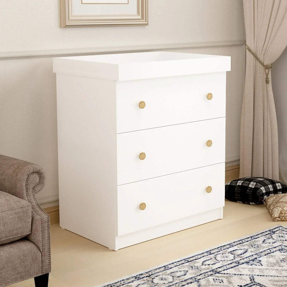 White kids changing dresser with three drawers and gold round knobs