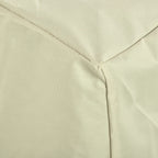 Close-up of beige chair cover fabric and stitched panel seams