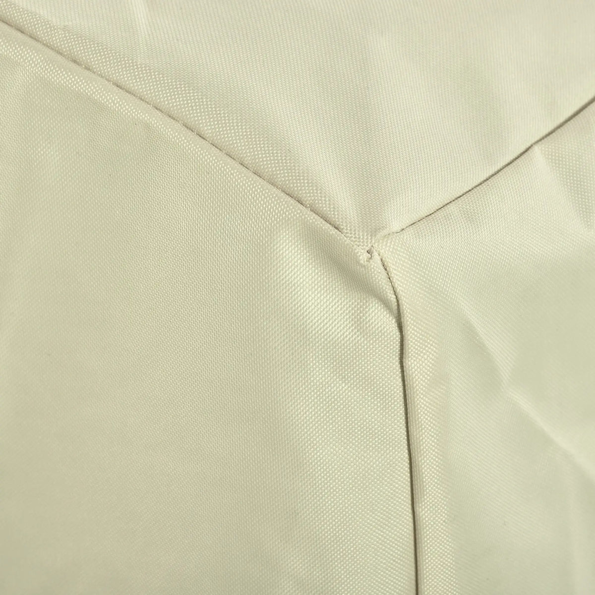 Close-up of beige chair cover fabric and stitched panel seams