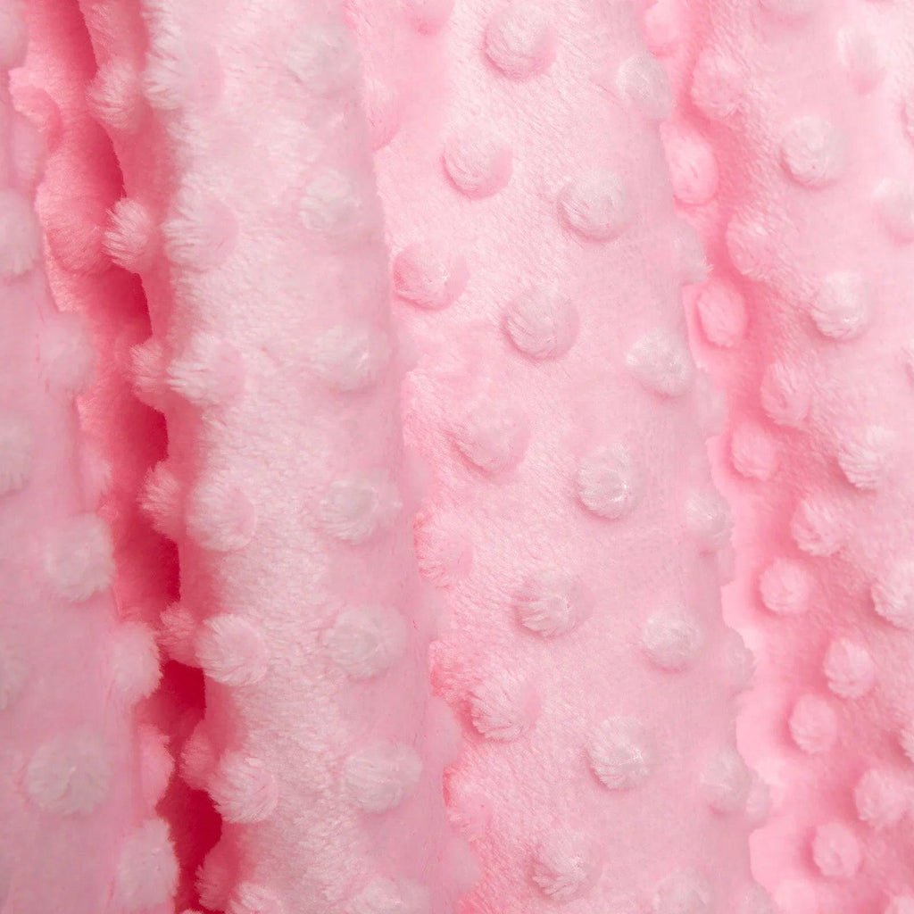 Close-up of pink fleece baby blanket with soft raised dot texture.