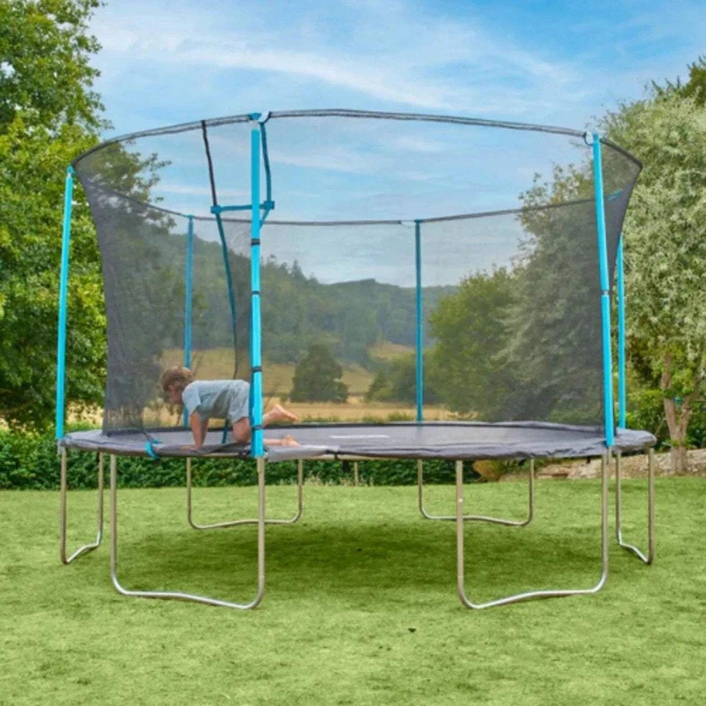 Outdoor trampoline with gray mesh walls, blue frame, and child on jumping mat