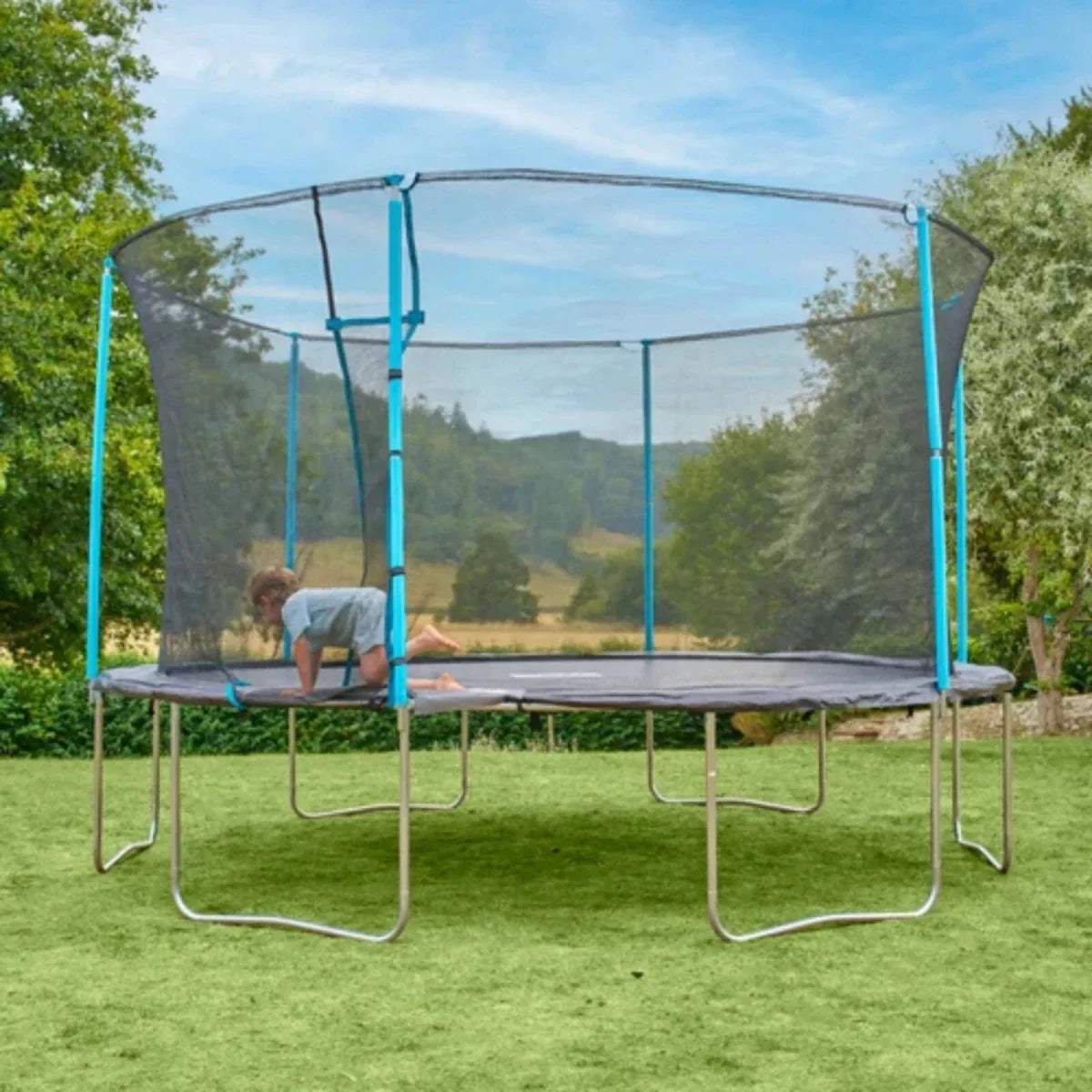 Outdoor trampoline with gray mesh walls, blue frame, and child on jumping mat