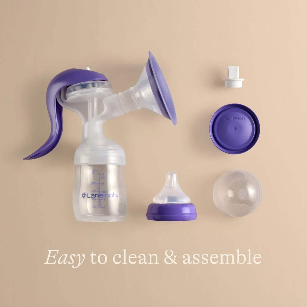 Lansinoh manual breast pump kit with purple flange parts, bottle, and white accessories
