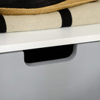 Close-up of white nightstand gray drawer front with cut-out handle