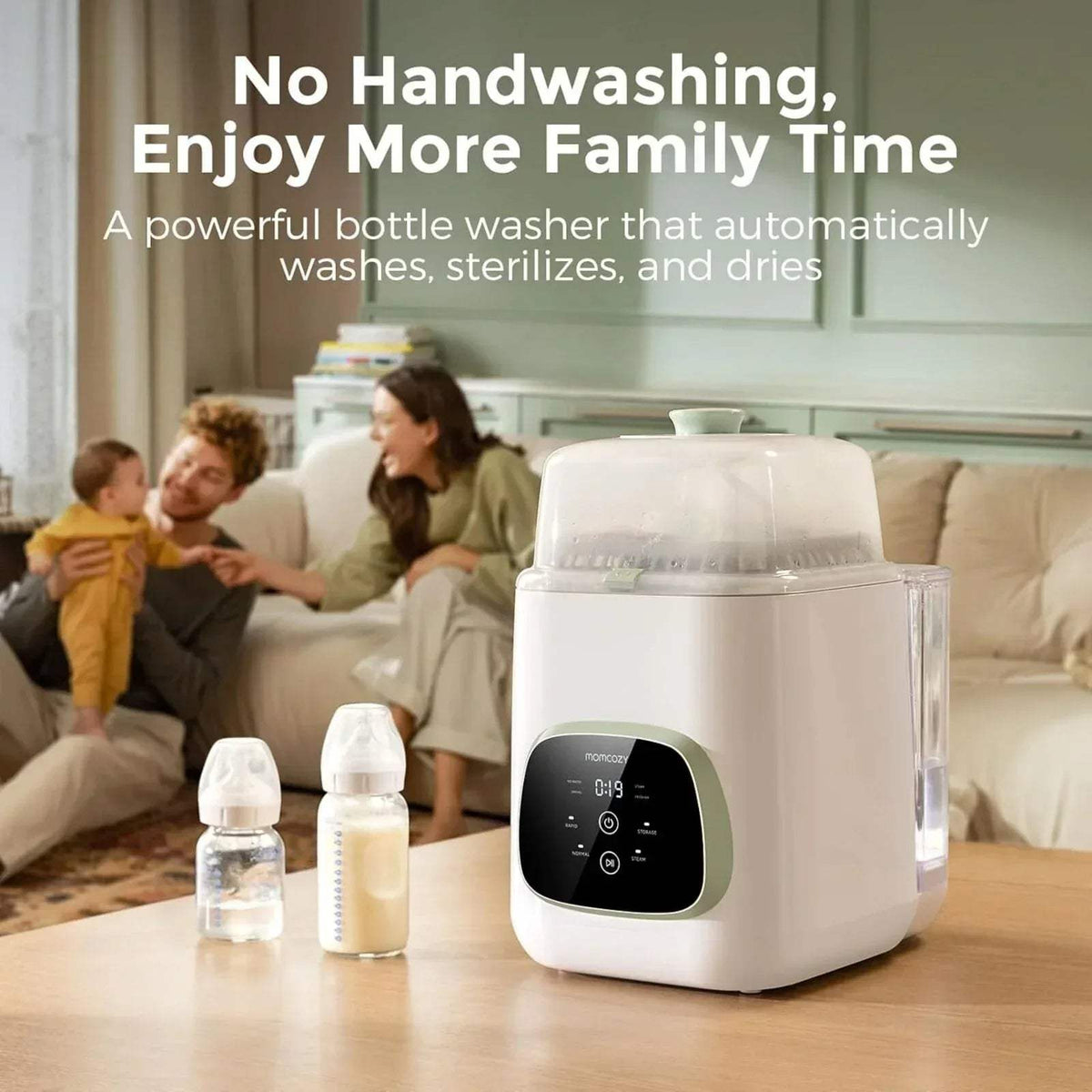 White Momcozy baby bottle washer steriliser dryer on table, front control panel visible