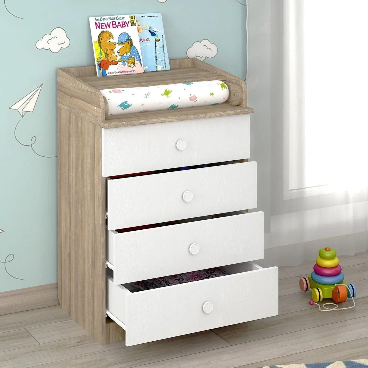 Kids changing dresser with elm frame, white drawer fronts, and top changing shelf