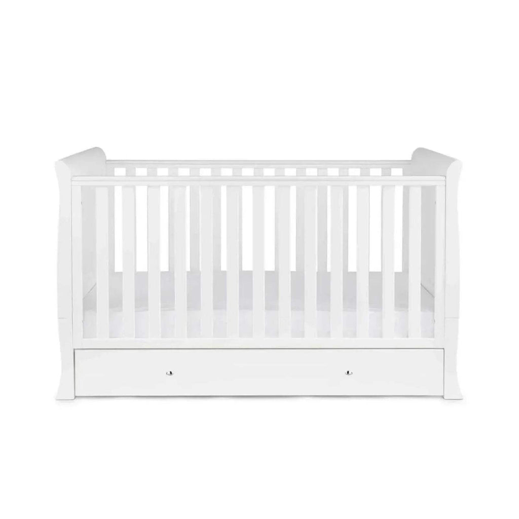 White cot bed with vertical slat rails and drawer base, without mattress.