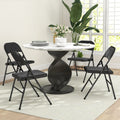 Set of four black folding chairs for dining, curved padded backs and seats
