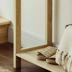 Natural wood console table with open lower shelf and woven drawer front detail.