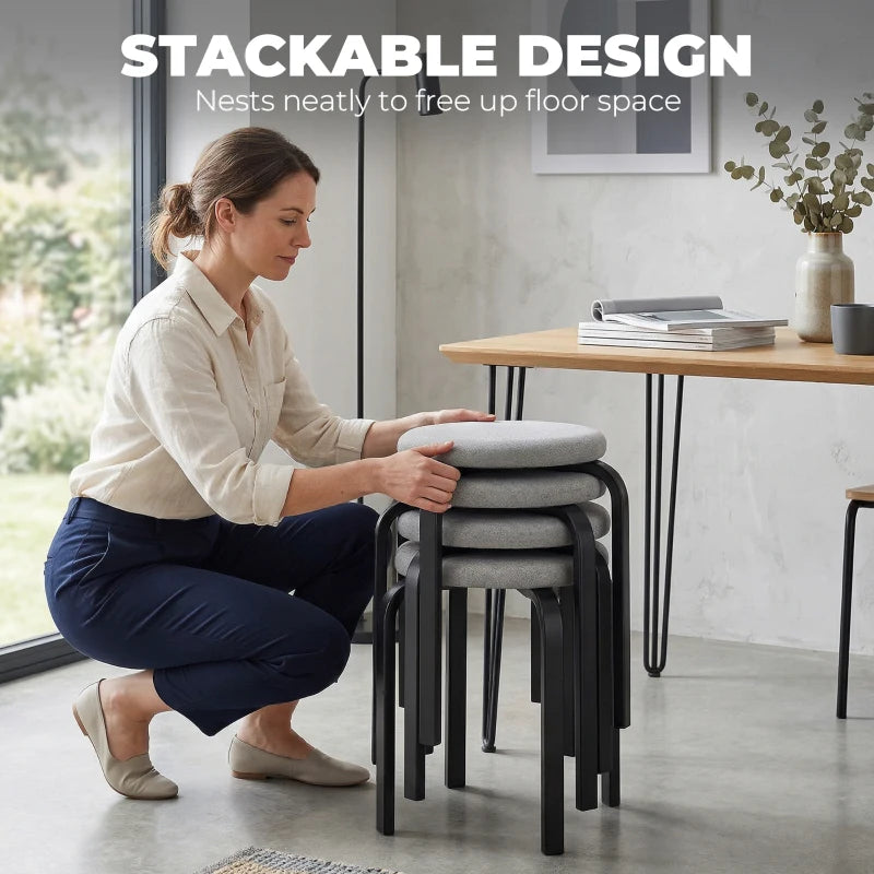Stackable grey backless stool with round cushioned seat and black metal legs
