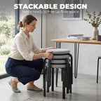 Stackable grey backless stool with round cushioned seat and black metal legs