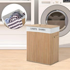 Natural wood laundry hamper with lid open, showing white removable liner and sorting use