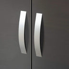 Silver curved handle on grey high-gloss wardrobe door