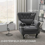Dark grey Chesterfield-style accent chair with button tufting and nailhead-trim arms