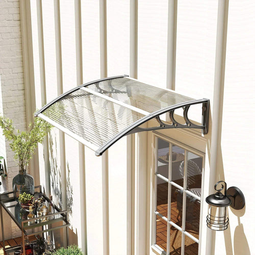 Clear arched doorway rain shelter awning with metal support frame and ridged plastic top