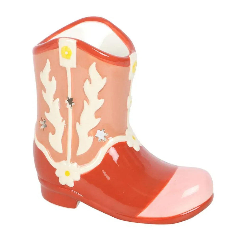 Orange cowboy boot oil warmer with white patterned sides and curved handle