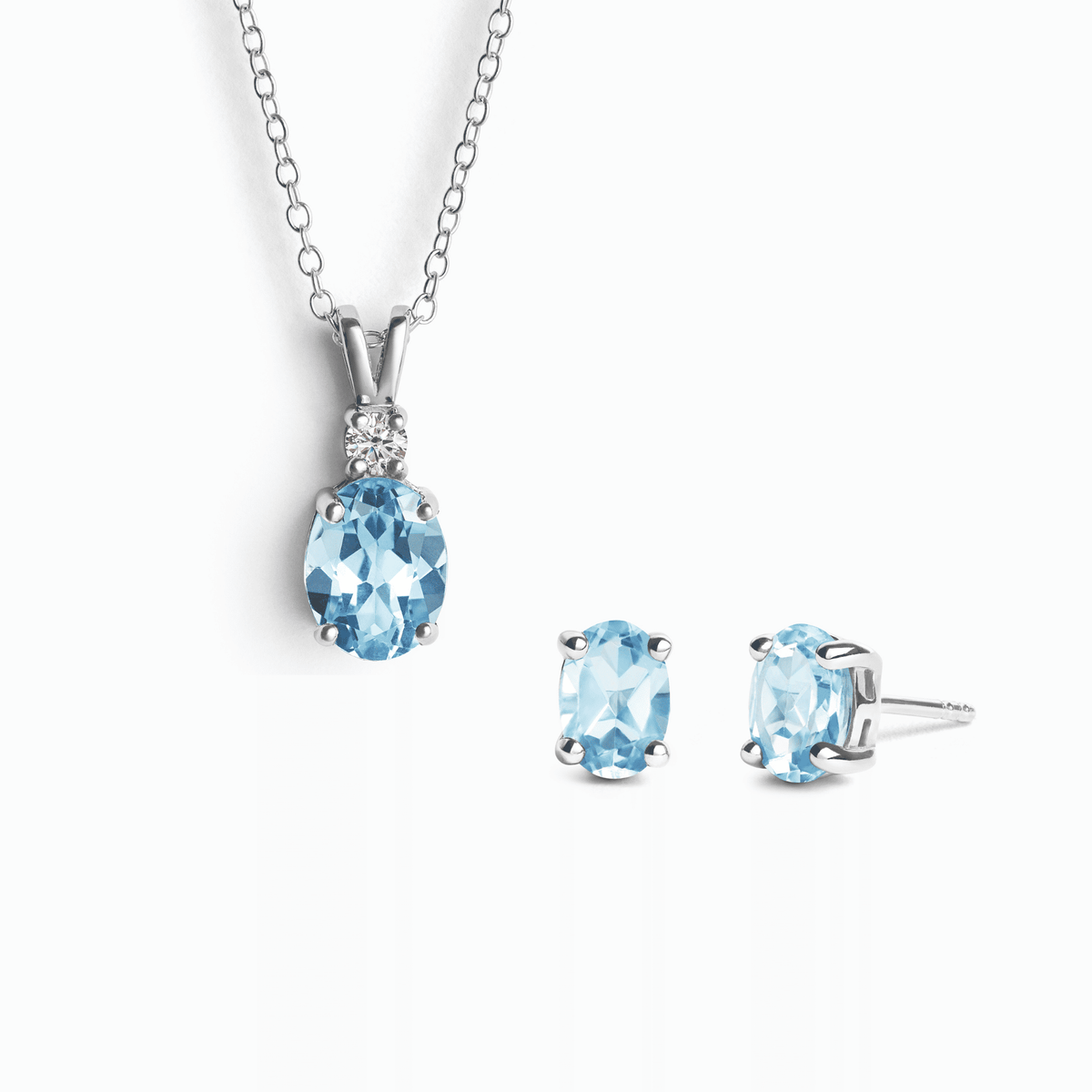 Sterling silver necklace pendant and stud earring set with blue topaz stones