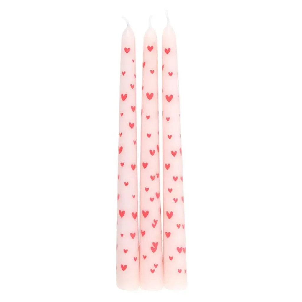 Three pink taper candles with small red hearts, straight shape