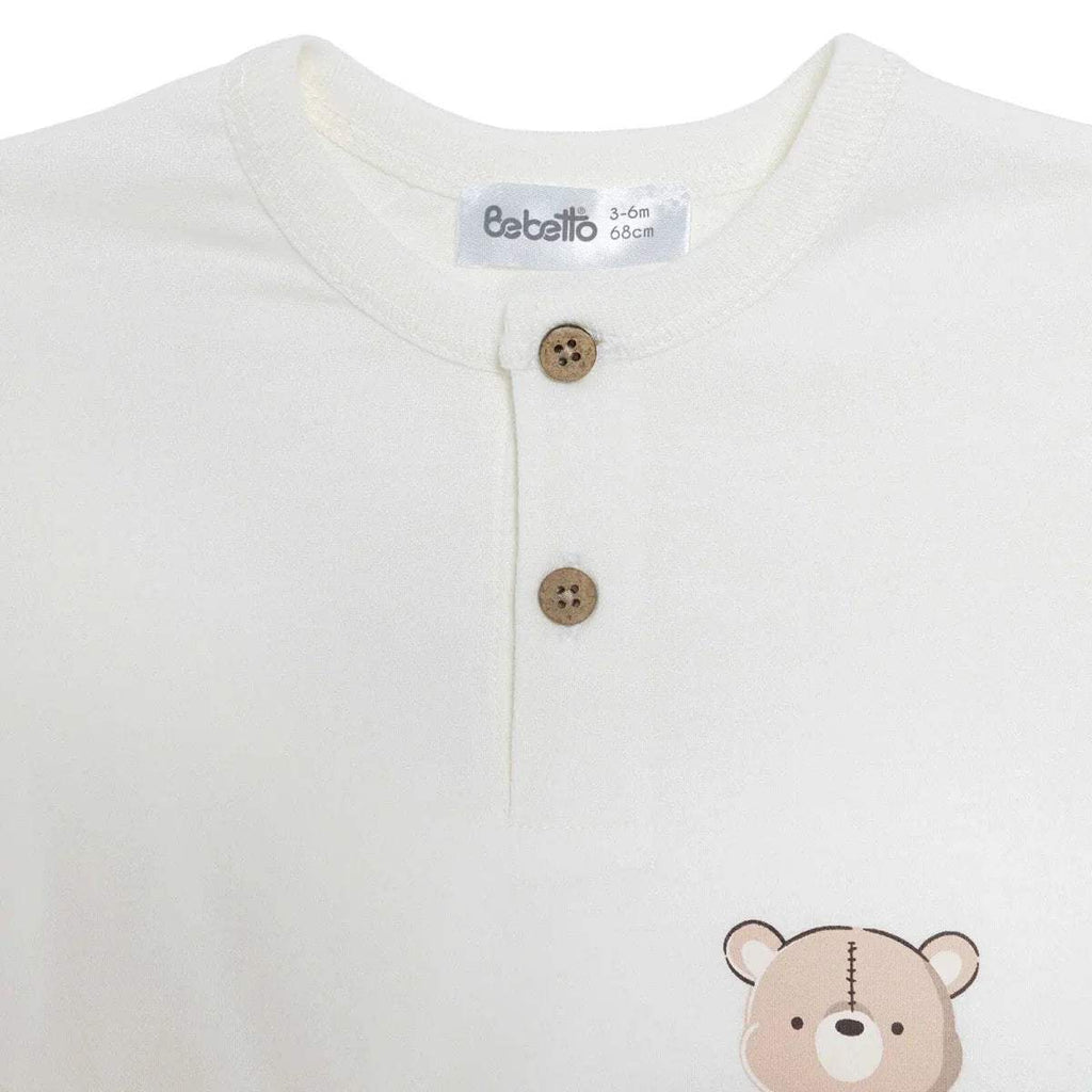 Boys white T-shirt close-up with wooden-look buttons and bear graphic