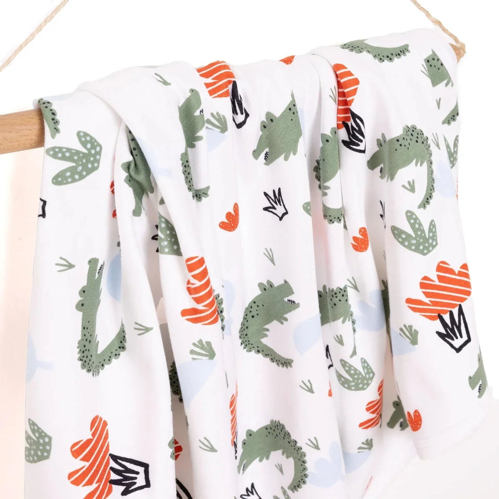 Folded white kids blanket with cactus and striped heart patterns