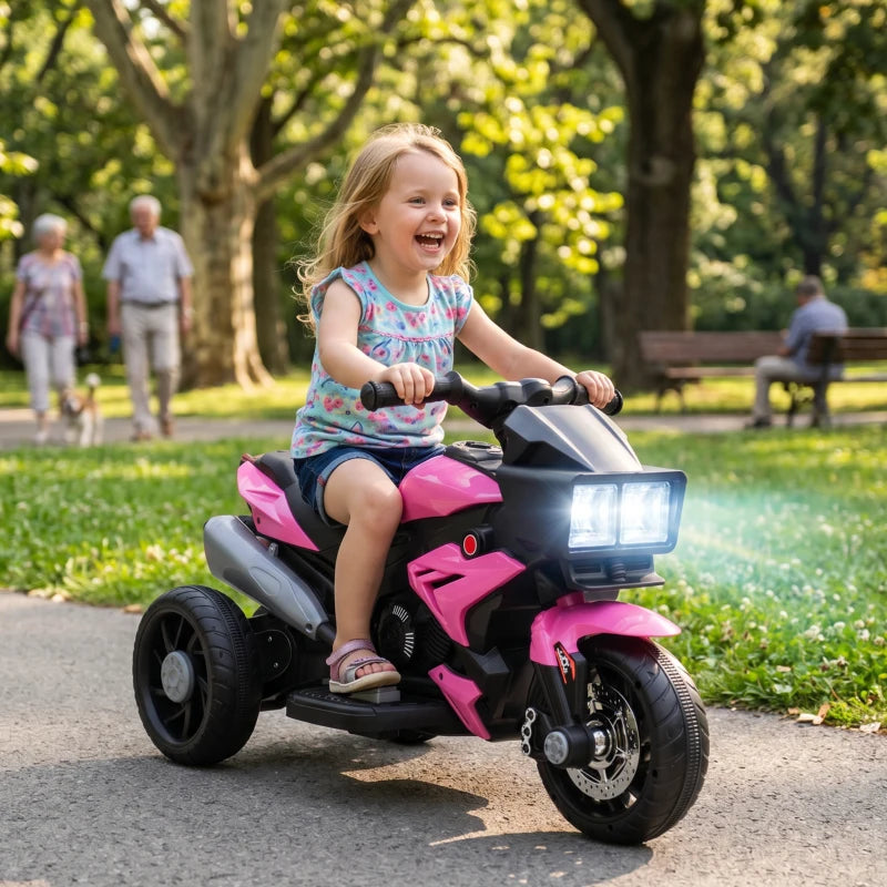 Pink and black 3-wheel ride-on motorcycle toy with front LED headlight and child rider.